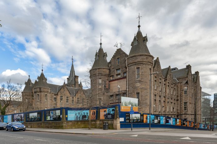 Edinburgh, Scotland - April 2018: Historic Scottish Baronial style buildings of the former Royal Infirmary of Edinburgh that was used as Old Surgical Hospital, now being restored by Quartermile Development for University of Edinburgh, Scotland, UK Extension project