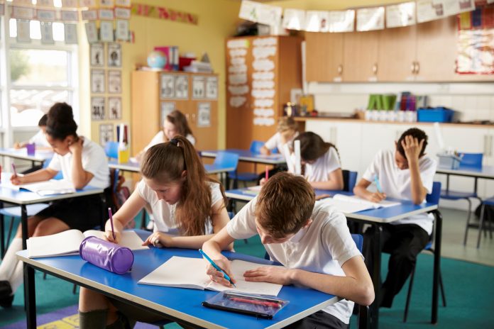 Class of primary school kids studying in a classroom School buildings,
