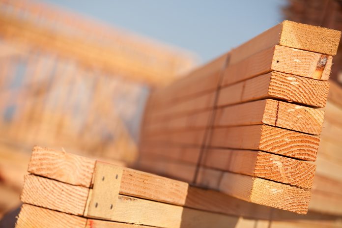 Stack of Building Lumber at Construction Site with Narrow Depth of Field. Build-in-Wood,