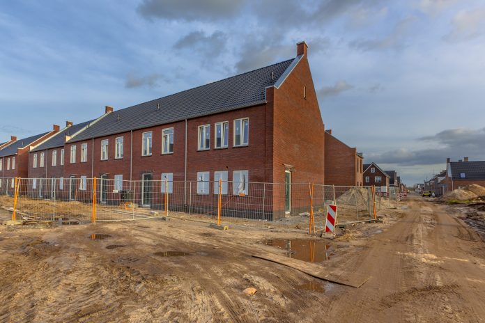 Newly built houses on building site new build homes, housing crisis,