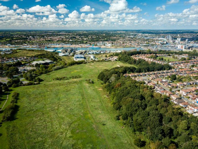 Aerial view of suburban houses in Ipswich, UK. River Orwell and housing crisis, rural campaigners, planning system,