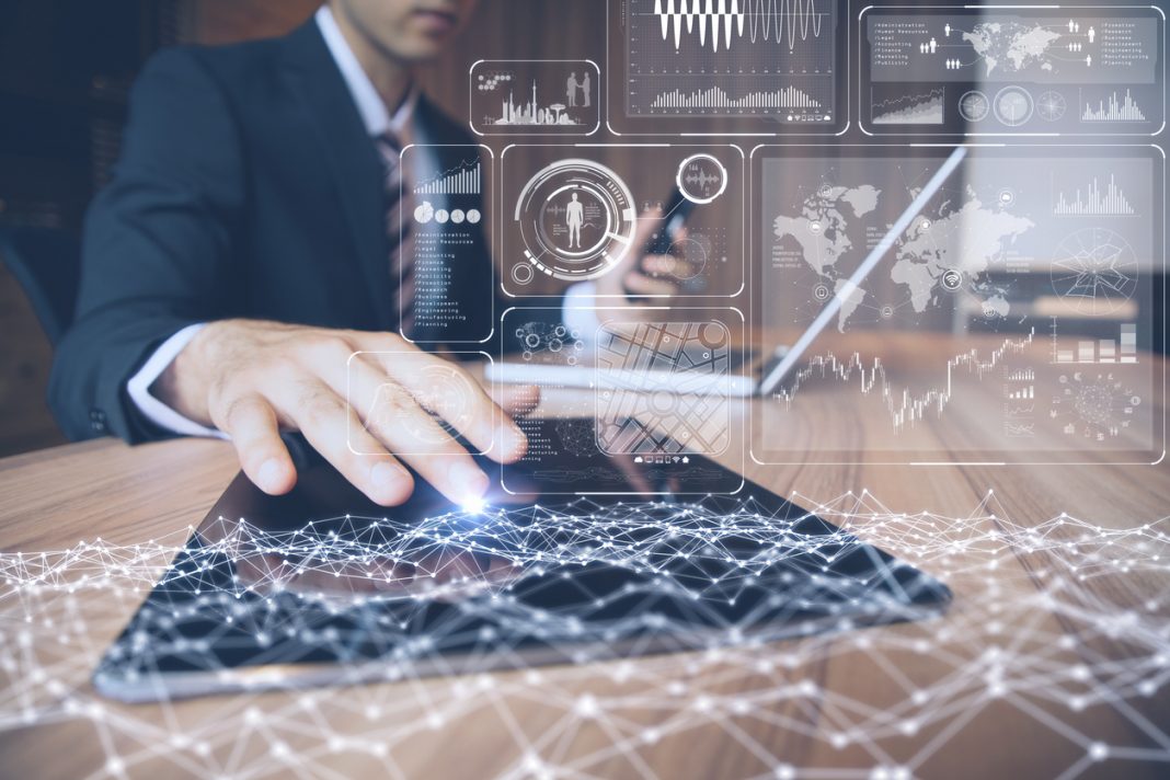 businessman using tablet PC and information communication technology concept. IoT(Internet of Things). GUI(graphical user interface). paperless office. smart buildings,