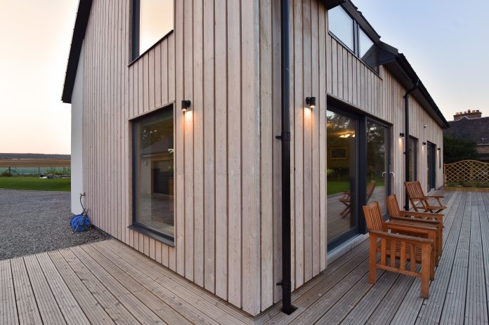 Fearnach House close up of corner showing cladding and render in twilight home extensions