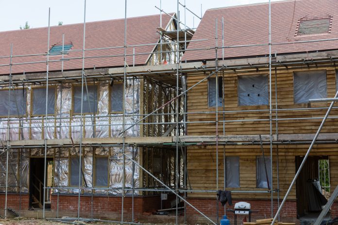 timber frame built house with scaffolding