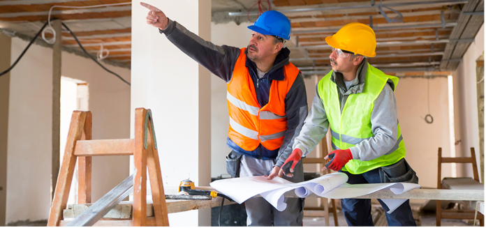 two builder discussing construction plans in new building