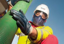 Image of worker holding wastewater pipe