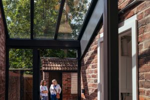 One Manchester chief executive Nicole Kershaw, right, with chief transformation officer Charlotte Grover at one of the renovated historic cottages at Westwood Cottages