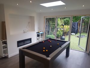 extended room in house looking out onto garden with pool (snooker) table