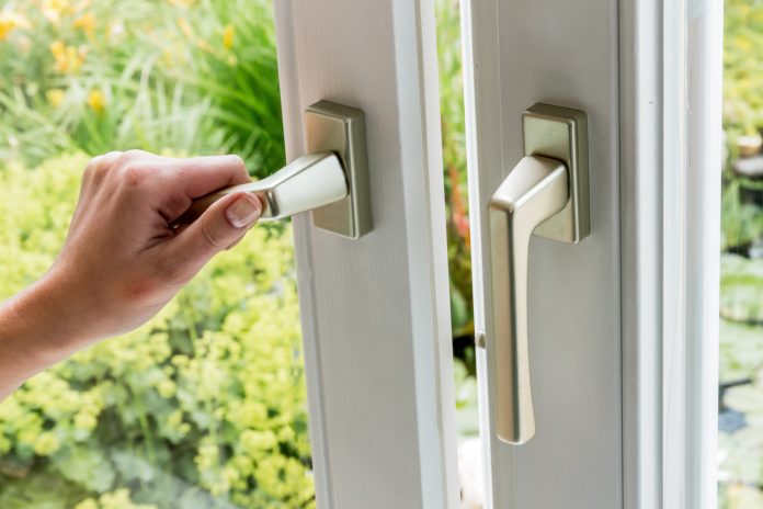 Woman Opens Window For Ventilation