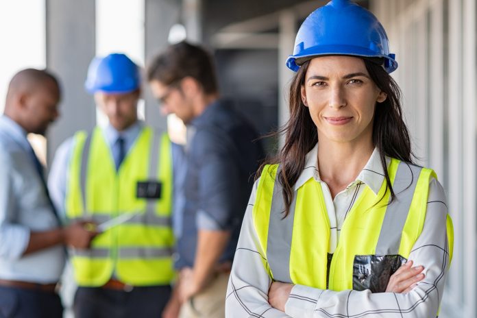 Stock Image of female construction worker on site wearing PPE