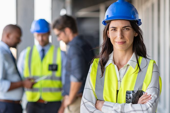 Stock Image of female construction worker on site wearing PPE
