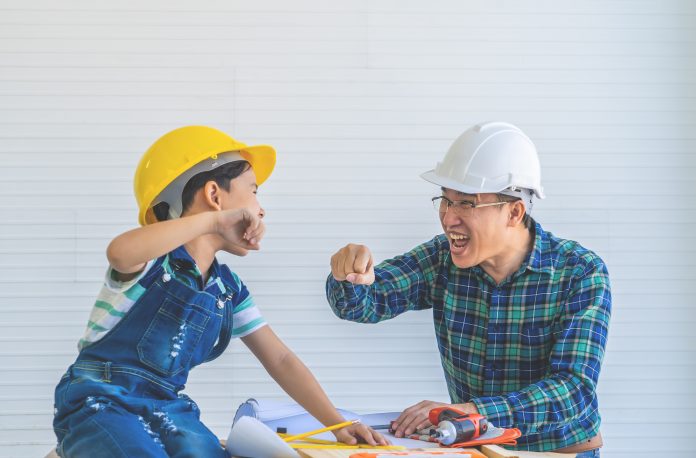 Father and Son fist bump for success concept in construction
