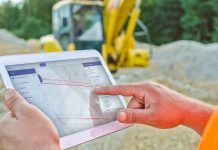 Construction Worker Using Tablet for Geospatial Data