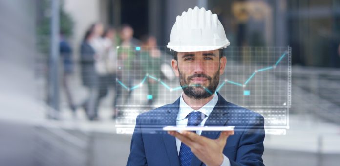 Image of construction worker using technology