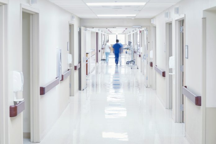 Doctor walking down hospital corridor