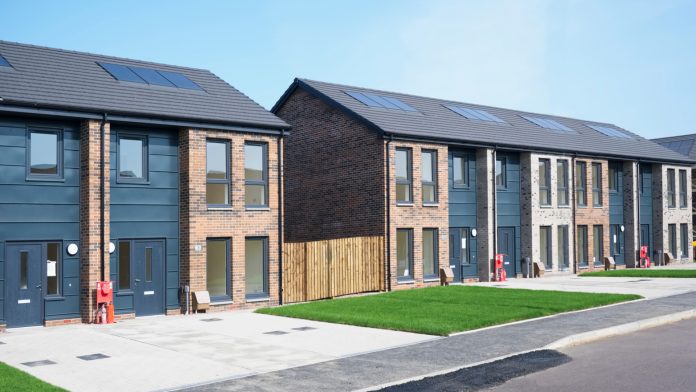 new build housing development, modern terraced houses with front gardens and driveway