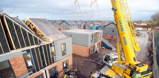 Modular contractors working on construction site to deliver offsite homes