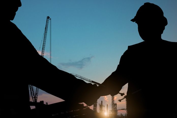 construction workers shaking hands