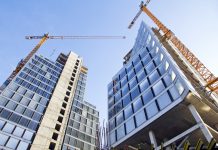 RICS courses and events: meet the future needs of the construction industry construction crane next to high rise building, view from bottom