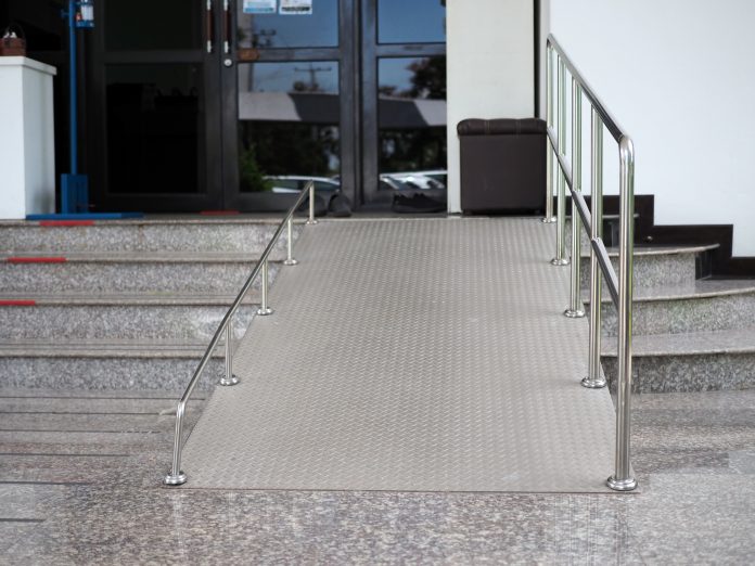 A ramp for disabled people going up and down outside a building