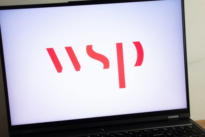 WSP logo on laptop screen - capita sells real estate and infrastructure consultancy businesses to wsp