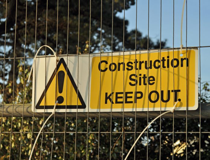warning sign on construction site to keep out