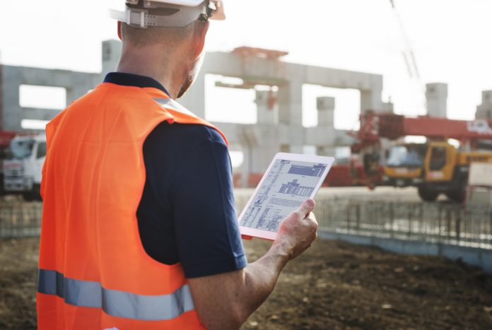 Image of construction worker onsite with tablet