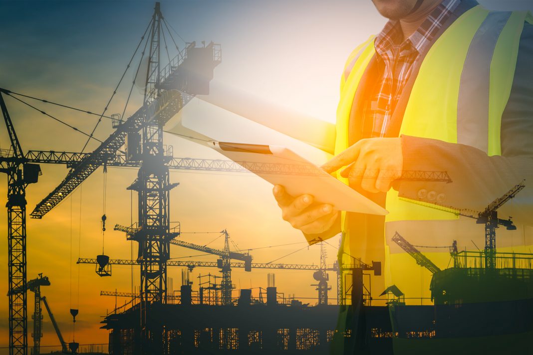 stock image of worker using construction technology
