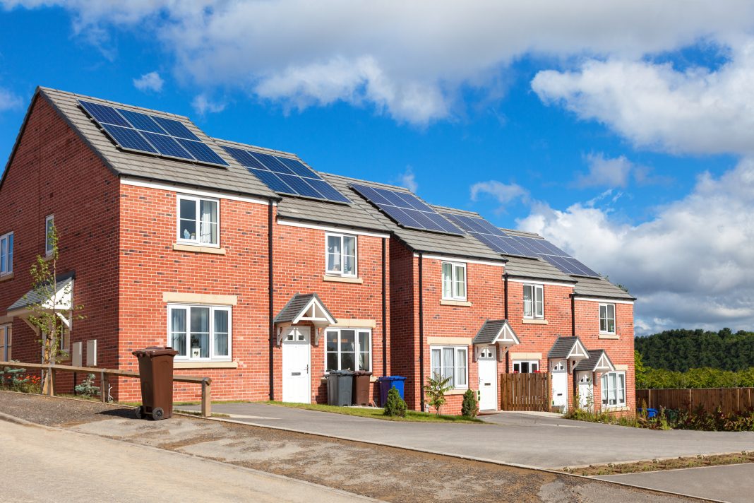 shutterstock_1063434026 Stock image of housing with solar panels