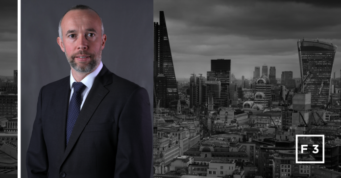 Jon Dixon, pictured against a steely grey city skyline background, has been selected as the new CEO of F3GROUP, with current CEO Gavin Gleave taking the role of executive chairman