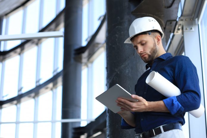 dreamstime_xxl_172717706 Shot of a engineer using a digital tablet on a construction site., considering legacy applications