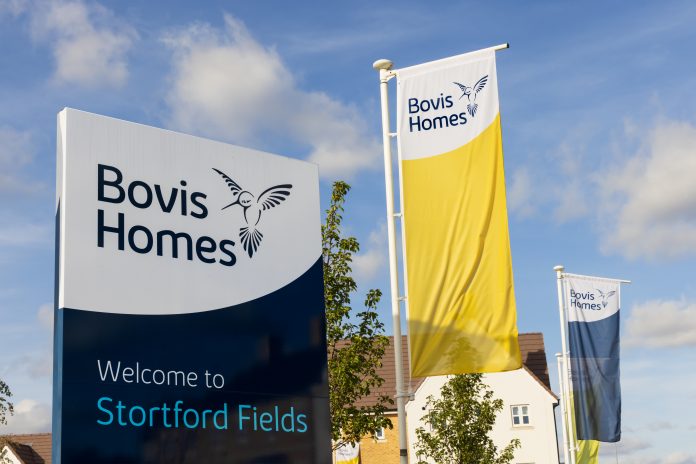 Bovis Homes (Vistry) sign and flags in the Stortford Fields housing development. Bishop`s Stortford, Hertfordshire
