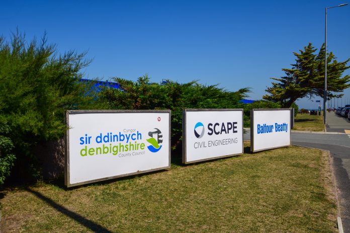 dreamstime_xxl_253824707 Three wood framed balfour beatty and scape signs at the entrance to a temporary works depot wales
