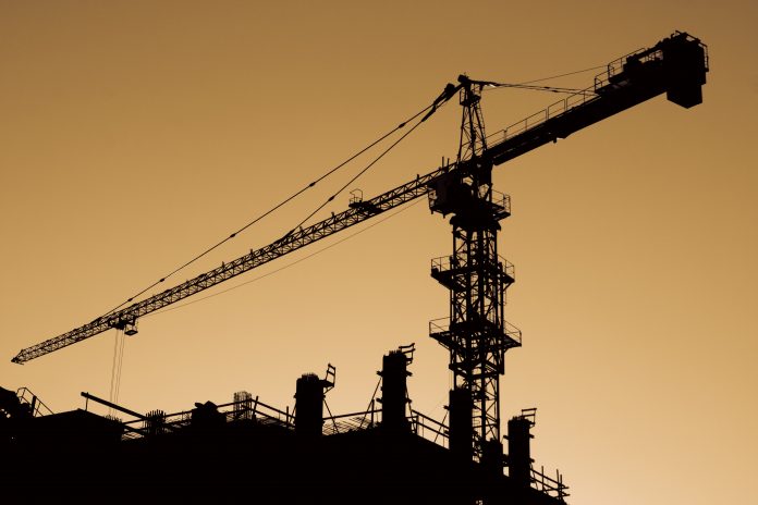 Silhouette of high crane at sunset