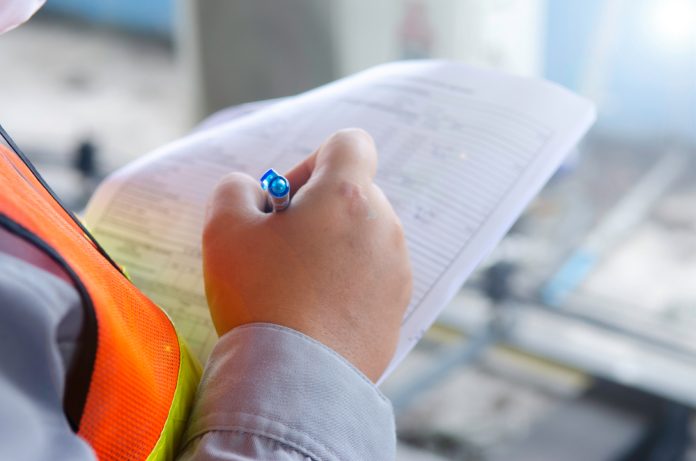 stock image of construction worker with plans