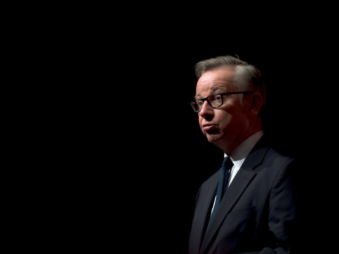Michael Gove against a black background