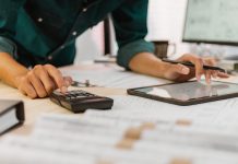 Is technology the future of construction estimating? person using tablet and calculator to work out construction estimating