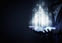 How can data help the construction industry achieve net zero objectives? Close up of businesswoman holding digital construction project in palms to represent achieving net zero