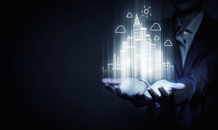 dreamstime_xxl_60481252 Close up of businesswoman holding digital construction project in palms to represent achieving net zero