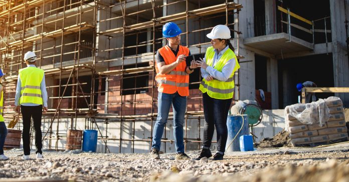 Four construction workers having meeting on site re Building Safety Act 2022 (BSA)