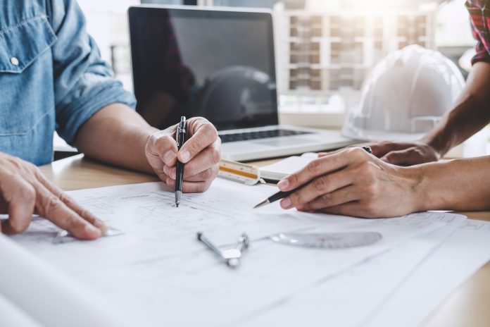 workers discussing construction paperwork