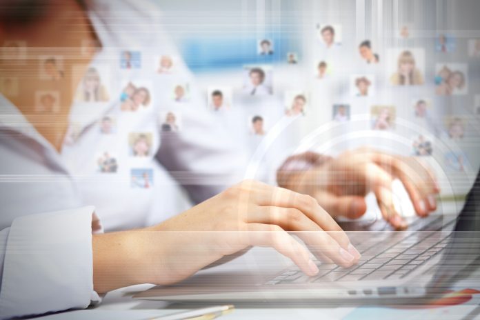 dreamstime_xxl_30651932 digital HR concept - person using laptop to communicate with employees