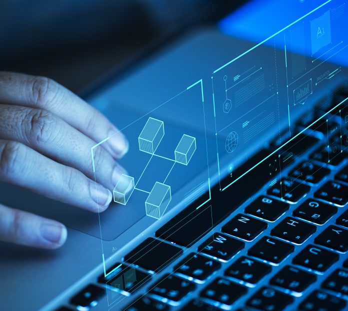 person scrolling on laptop for data in construction