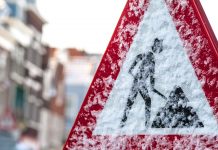 Working in cold weather: How can construction employers mitigate risk? construction sign in cold weather