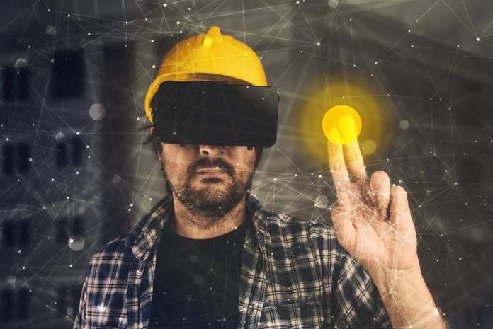 Construction technology trends:Construction engineer with VR goggles managing building project