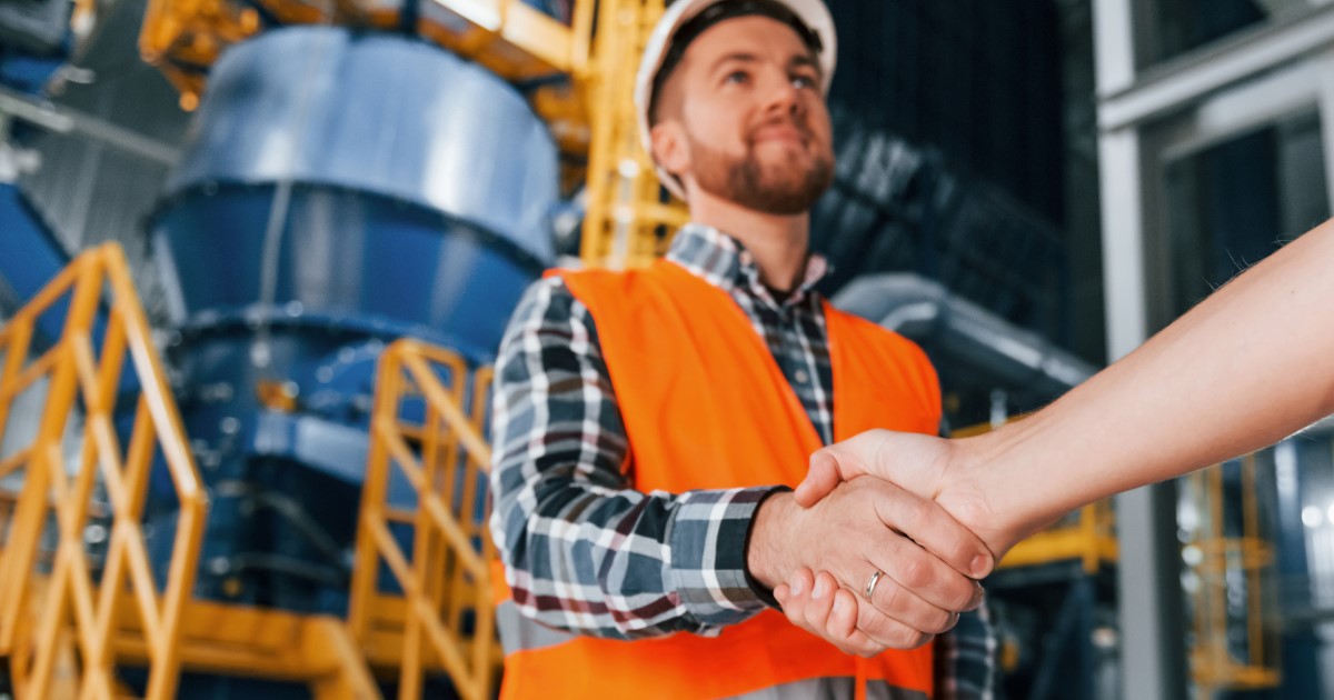 Re-flow field management worker shaking hands