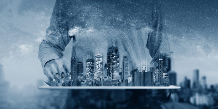 digital tablet with buildings hologram