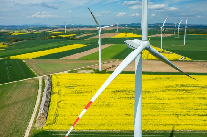 Aerial view on the windmills on the yellow field representing infrastructure in 2023