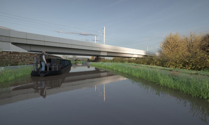 Canal boat approaching the Oxford Canal Viaduct, Warwickshire ironstone cladding