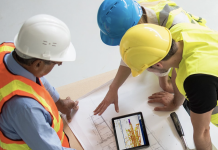 Announcing Viewpoint For Projects and Microsoft 365 integration 3 construction workers using Viewpoint For Projects on tablet